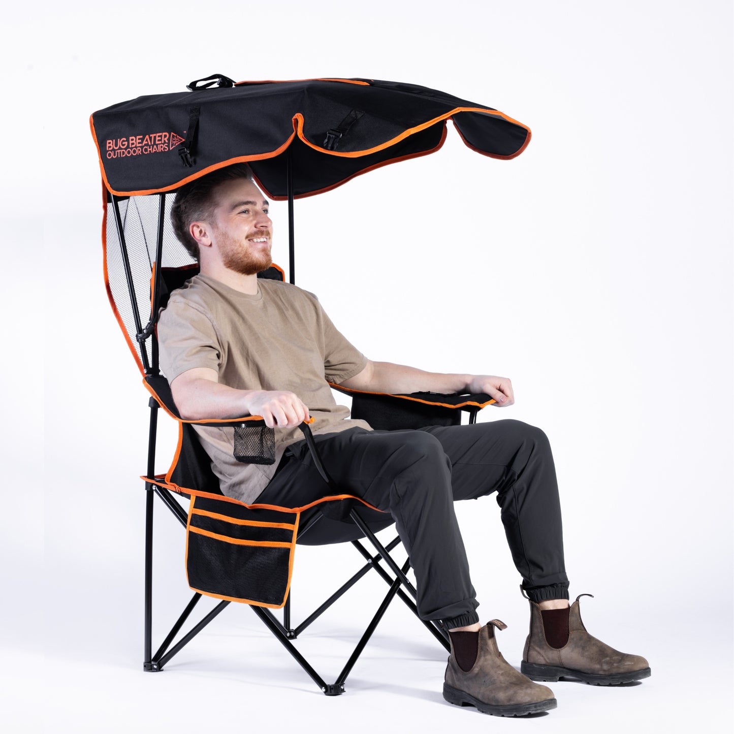 A man sitting in the Bug Beater 2.0, with the canopy extended and no net, against a white background.