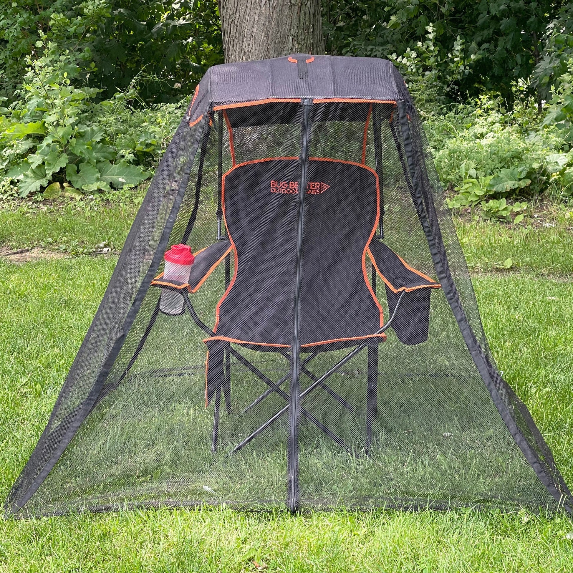 A Bug Beater 2.0 chair fully unfolded, featuring a built-in beverage cooler in the left arm and a fully extended UV protective canopy with a fire-resistant bug net surrounding.