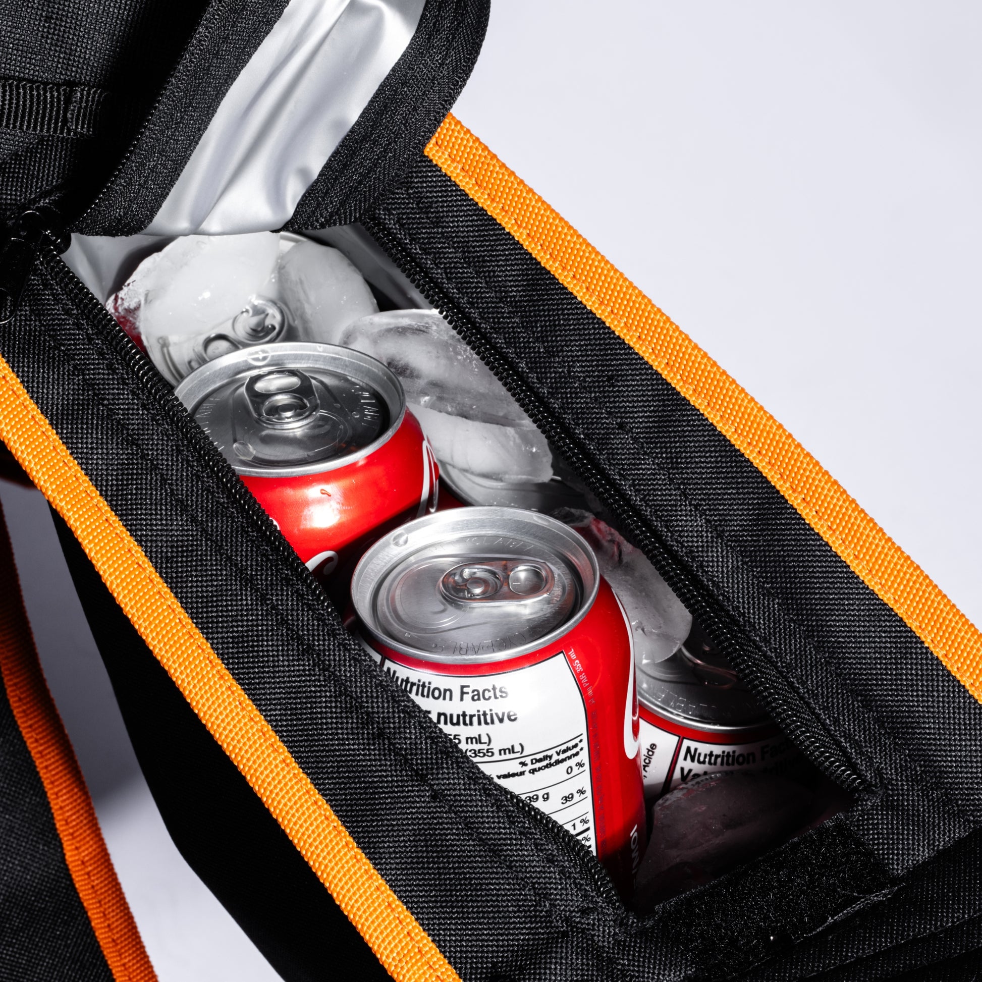 A close-up image of the Bug Beater's built-in 5-can cooler bag located on the left arm of the chair, against a white background.